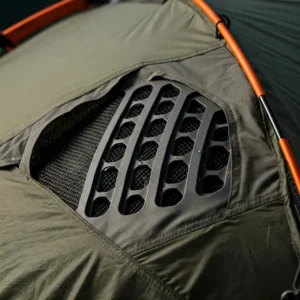Close-up of the ventilation system on an avalanche backpack tent, ensuring airflow and reducing condensation.