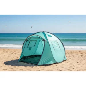 A personal pop up tent set up on a sandy beach for shade and privacy.