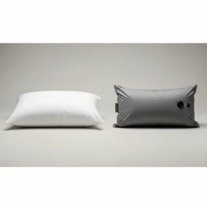 A side-by-side comparison of a regular pillow and a compact camping pillow, illustrating the size difference.