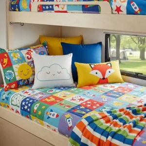 Fun and colorful bedding, including sheets and pillows, on a camper bunk bed for a child.