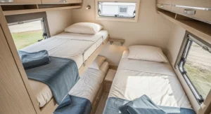 An overhead shot of a neatly made bunk bed inside a camper, featuring soft, wrinkle-free sheets that promise a comfortable sleep.