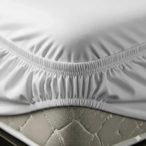 A close-up shot of the elasticized corners of an RV king fitted sheet, demonstrating its snug fit and secure hold on an RV mattress.