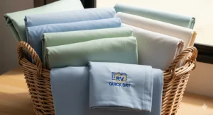 A laundry basket filled with freshly washed and dried rv camper sheets, emphasizing their easy-care, quick-drying properties.