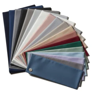 A fan of fabric swatches displaying the various color options available for our luxury short queen sheet sets.