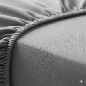 A close-up shot of the high-quality cotton fabric of the short queen fitted sheet, showing its weave and soft texture.