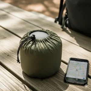 An ultralight camping pillow compressed and packed into its small stuff sack, showing its minimal packed size for backpackers.