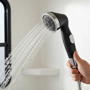 High-pressure handheld sprayer connected to the camper shower faucet, ideal for efficient water use.