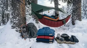 Layers of thermal base layers, wool socks, and a down jacket for winter hammock camping.