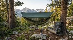 Illustration of an ultralight hammock setup with a waterproof rain tarp for backpacking.
