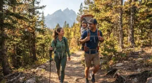 Family enjoying a weekend nature walk using a child carrier backpack for hiking