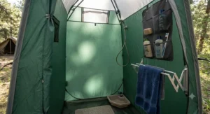 Interior view of a heavy-duty camp shower tent featuring a hanging pocket and towel rack.