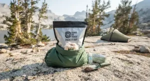 Secure waste bag used for packing out used camping toilet paper in Leave No Trace alpine zones.