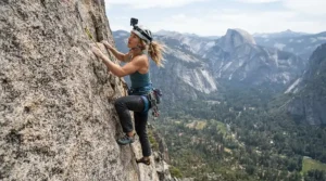 Rugged action camera for camping recording a rock climber scaling a granite cliff face