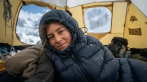 Close-up of a winter sleeping bag for women featuring advanced draft collar technology in an alpine tent.